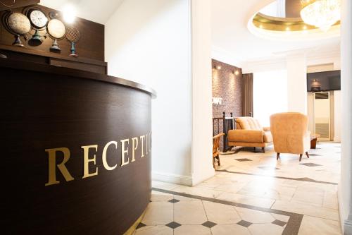 a reception area of a hotel lobby with a reception desk at Hotel Diplomat in Tbilisi City