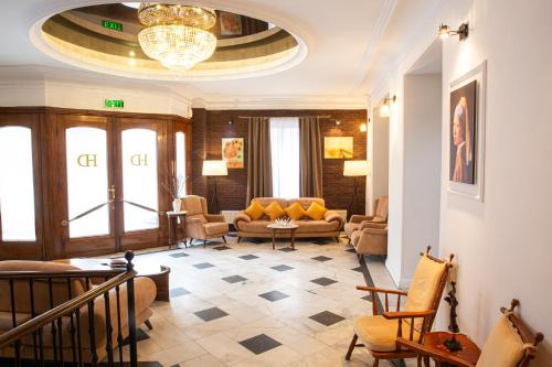 a living room with a couch and chairs at Hotel Diplomat in Tbilisi City