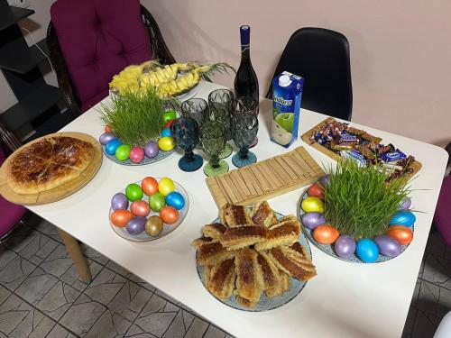 a table with bowls of easter eggs and food at The Friends in Yerevan