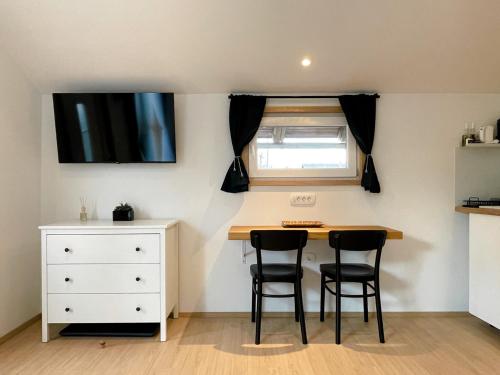 a small kitchen with a table and two chairs at Lodge Pia in Bled