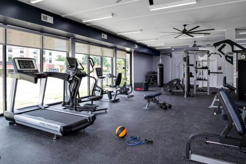 a gym with several treadms and machines in a room at Grand Two Bedroom Two Bathroom Apartment with Balcony in Gainesville