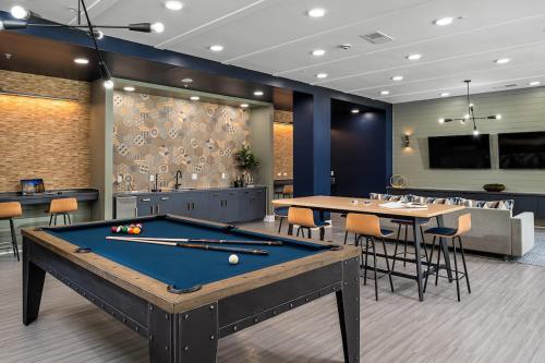 a billiard room with a pool table and tables at Grand Two Bedroom Two Bathroom Apartment with Balcony in Gainesville