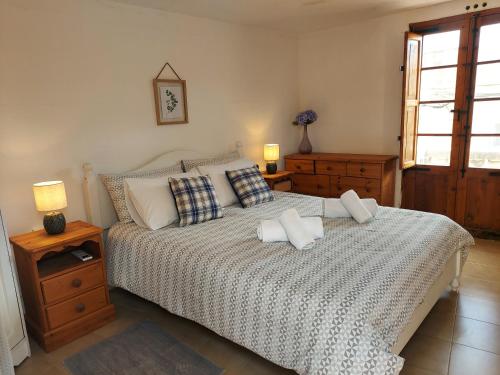 a bedroom with a bed with two pillows on it at Razzett Warda B&B in Għasri