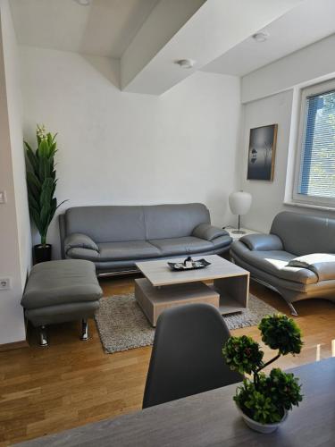 a living room with a couch and a table at EApartment in Skopje