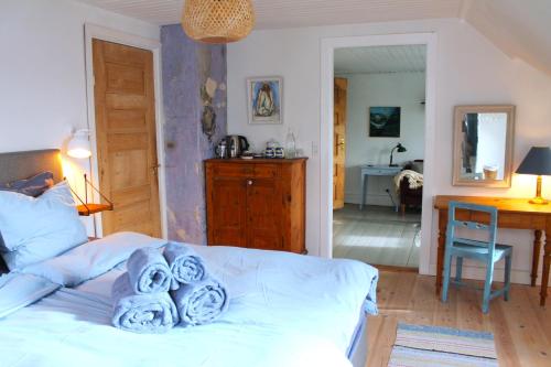 a bedroom with a bed with towels on it at Rosenhøj Bed and Breakfast in Svendborg