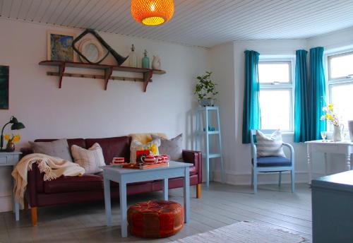 a living room with a couch and a table at Rosenhøj Bed and Breakfast in Svendborg