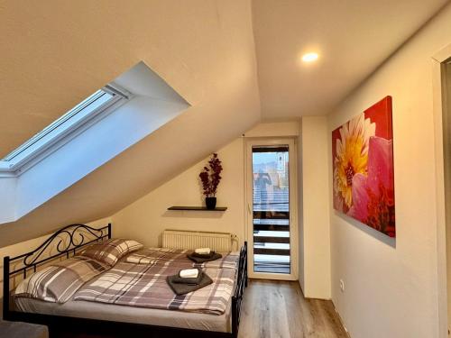 a bedroom with a bed in a room with a window at Aria apartment in Mošnje