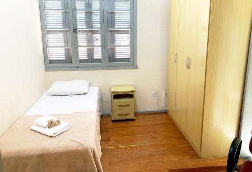 Una cama o camas en una habitación de Hotel Pousada São Lourenço