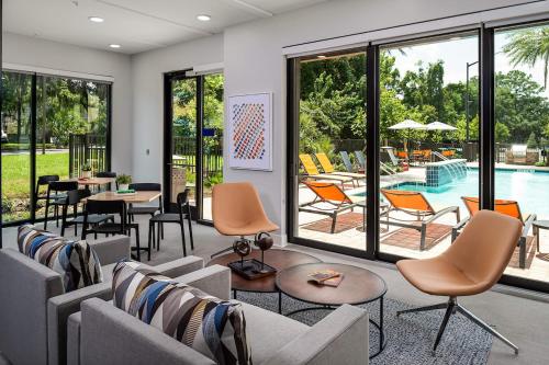 a living room with couches and chairs and a pool at Deluxe One Bedroom Apartment in Gainesville