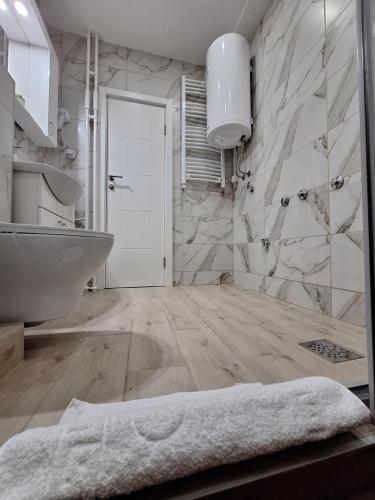 a bathroom with a tub and a sink at Relax Lux apartment Nis in Niš