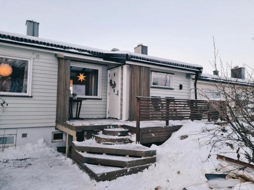 a house in the snow with a star in the window at Luxury Mountain Apt with Sauna in Narvik