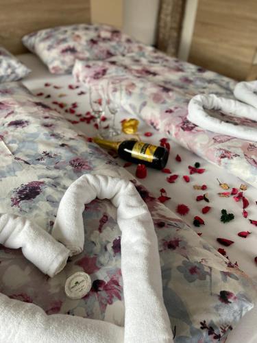 a bed covered in confetti with a bottle on it at Hotel Irish in Bihać