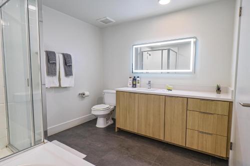 La salle de bains est pourvue de toilettes, d'un lavabo et d'une douche. dans l'établissement Modern 2BD & 2BTH Santa Monica 5 min to the Pier, à Los Angeles