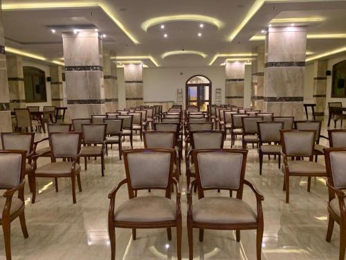 a row of chairs in a large room at Badr Hotel & Resort El Kharga in Kharga