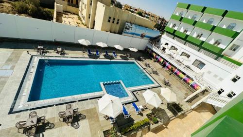 an overhead view of a swimming pool on top of a building at Badr Hotel & Resort El Kharga in Kharga