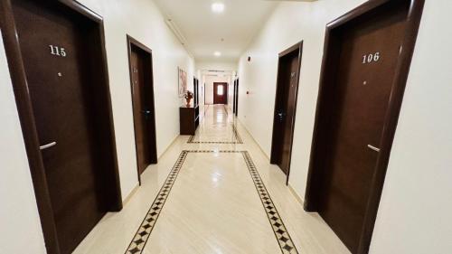 a hallway of a hotel with brown doors at Badr Hotel & Resort El Kharga in Kharga