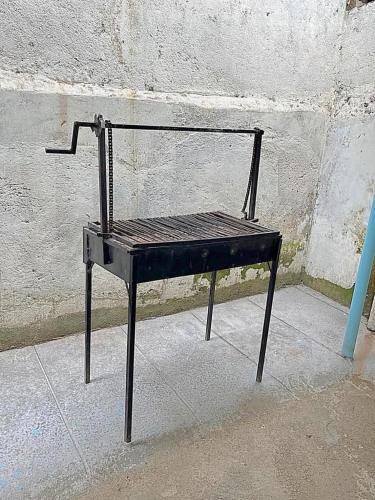a black bench sitting in front of a wall at Homely apartments 4 in Kisumu