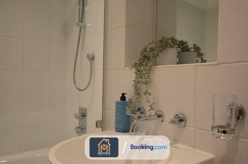a bathroom with a sink and a shower and a sink at LGI Stunning 1 Bedroom Apartment By Movida Property Group Short Lets & Serviced Accommodation in Leeds