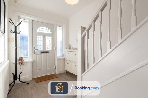 a white staircase in a home with a window at Large Modern 6 Bedroom House By Movida Property Group Short Lets & Serviced Accommodation With Games Room in Adel