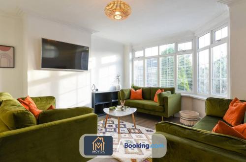 a living room with two couches and a tv at Large Modern 6 Bedroom House By Movida Property Group Short Lets & Serviced Accommodation With Games Room in Adel
