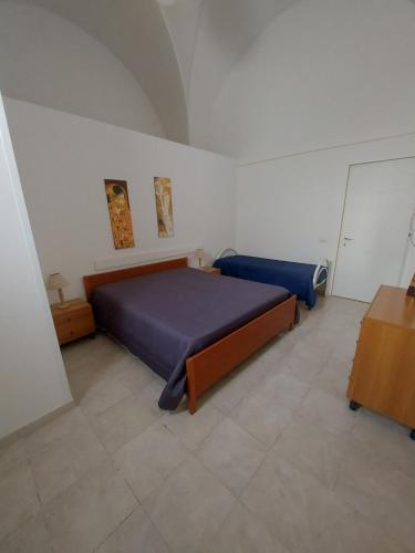 a bedroom with a blue bed in a room at Casina Arianna in Leverano