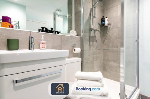 a bathroom with a shower and a sink at Stylish Two Bed City Centre Apartment By Movida Property Group Short Lets & Serviced Accommodation Leeds in Leeds