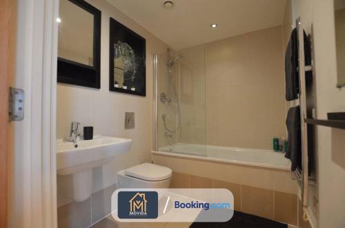a bathroom with a sink and a toilet and a bath tub at One Bed Docklands By Movida Property Group Short Lets & Serviced Accommodation Hunslet in Hunslet