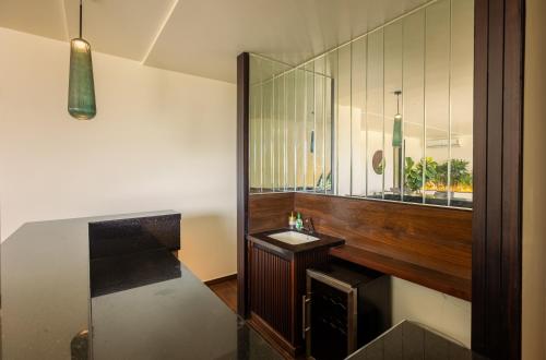 a bathroom with a sink and a mirror at Oak 5 in Bangalore