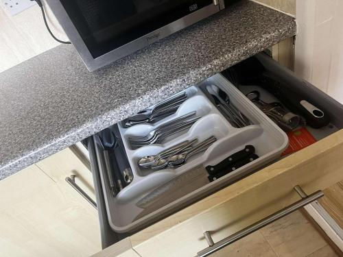 a kitchen sink with utensils in a drawer at Robinhuts Stays - 3 Bed property Perfect for contractors and families in Hull