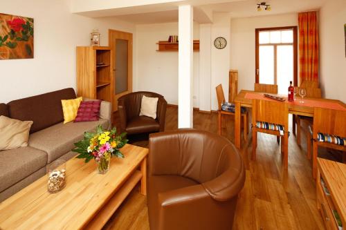 a living room with a couch and a table at Ferienwohnung Morgensonne in Bad Berka