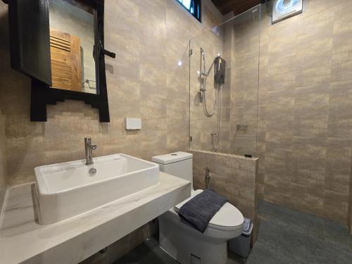 a bathroom with a sink and a toilet and a shower at Baan Koh Kwang Pool Villa Krabi in Krabi town