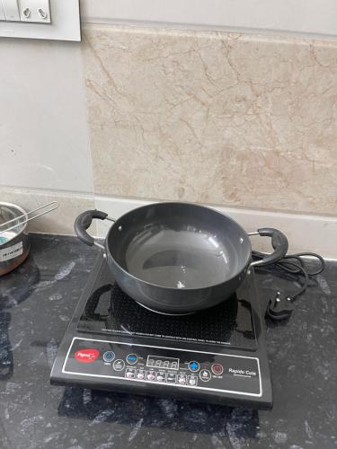a pan sitting on top of a stove at Sun Home Stays - Spacious Rooms - New Property - Pleasant Location in Tirupati