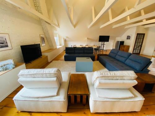 a living room with two couches and a table at Maison TURCOT in Saint-Hyacinthe