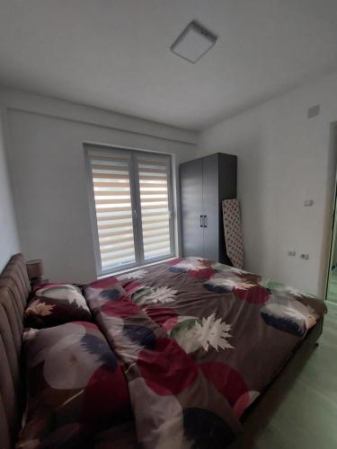 a bedroom with a bed with a blanket on it at Lili`s Apartment in Kumanovo