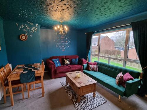 a living room with a couch and a table at Apartment 9 3/4 in Watford