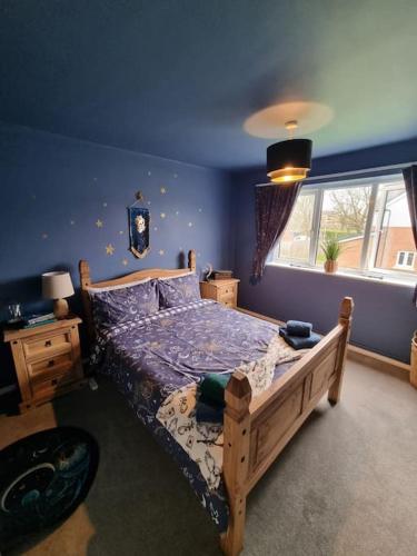 a bedroom with a wooden bed and a window at Apartment 9 3/4 in Watford