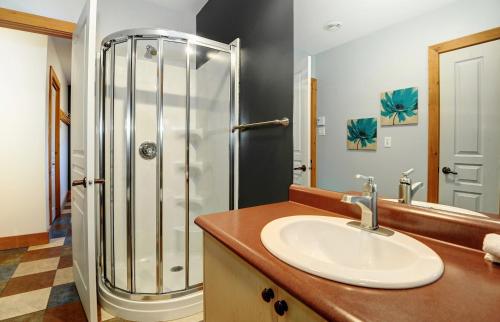 a bathroom with a sink and a shower at Chalet 9006 Chemin des Alpages by Les Chalets Alpins in Stoneham