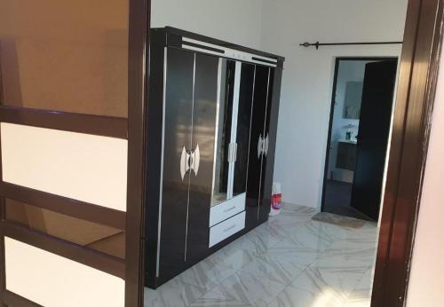 a sliding glass door with a reflection of a bathroom at Belle Appartement avec Jaccuzzi à Diamniadio in Dakar