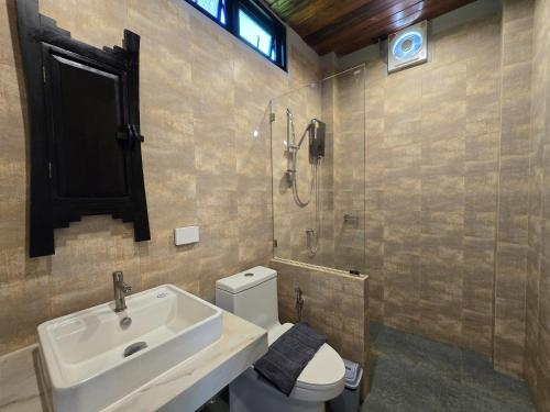 a bathroom with a sink and a toilet and a shower at Baan Koh Kwang Pool Villa Krabi in Krabi town