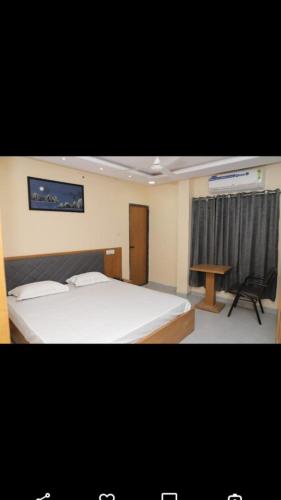 a bedroom with a bed and a desk and a table at HOTEL PARADISE INN in Shinaya