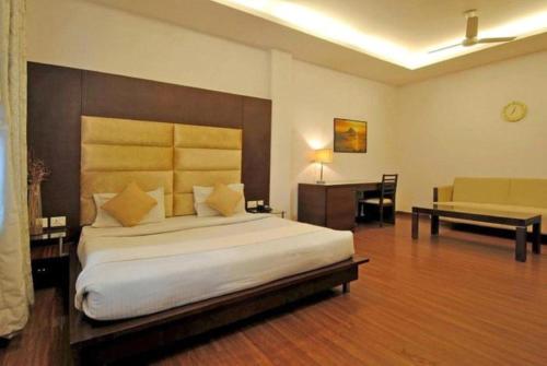 - une grande chambre avec un grand lit et un bureau dans l'établissement Del Fox Hotel Shanti Residency At New Delhi Railway Station, à New Delhi