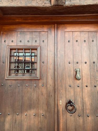 a wooden garage door with a window on it at Aristotelous Alexandrou Historic Inn in Arnaia