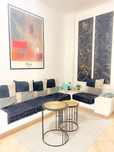 a living room with a couch and a table at Orchidea in Bari