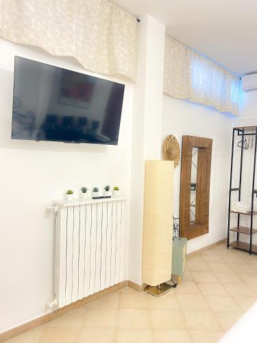a living room with a flat screen tv on a wall at Orchidea in Bari