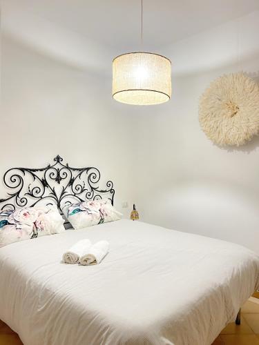 a bedroom with a bed with two towels on it at Orchidea in Bari
