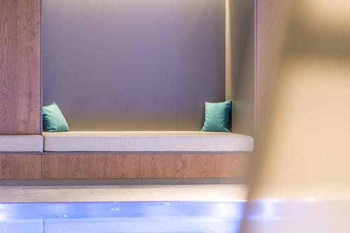 two pillows sitting on a bench in a room at Mountain Residence Montana in Santa Maddalena in Casies