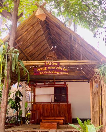 a building with a sign that reads wet cafeampire inside out sins at ameliehouse​ in Luang Prabang