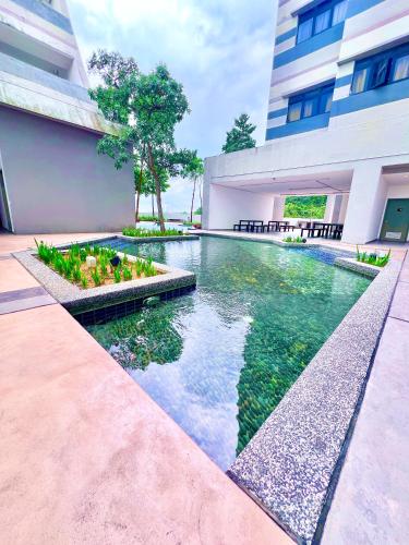 a swimming pool in the middle of a building at Legoland-8min walk at Kairos Comfort Spacious Suite for Families 1-12pax in Nusajaya