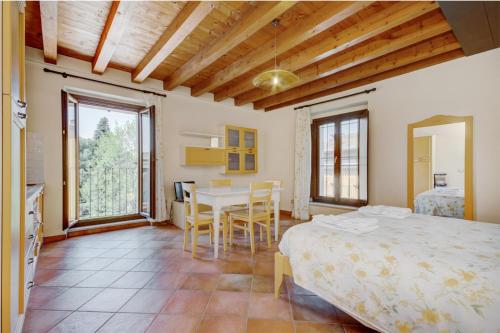 a bedroom with a bed and a table and chairs at Agriturismo La Filanda in Manerba del Garda