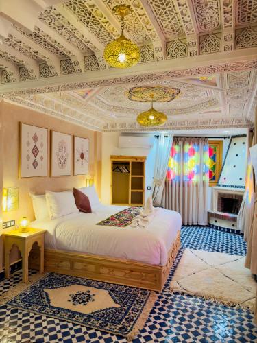 a bedroom with a bed and a coffered ceiling at Dar MD in Chefchaouene